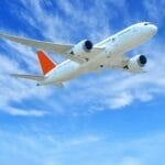 Airplane flying in blue sky